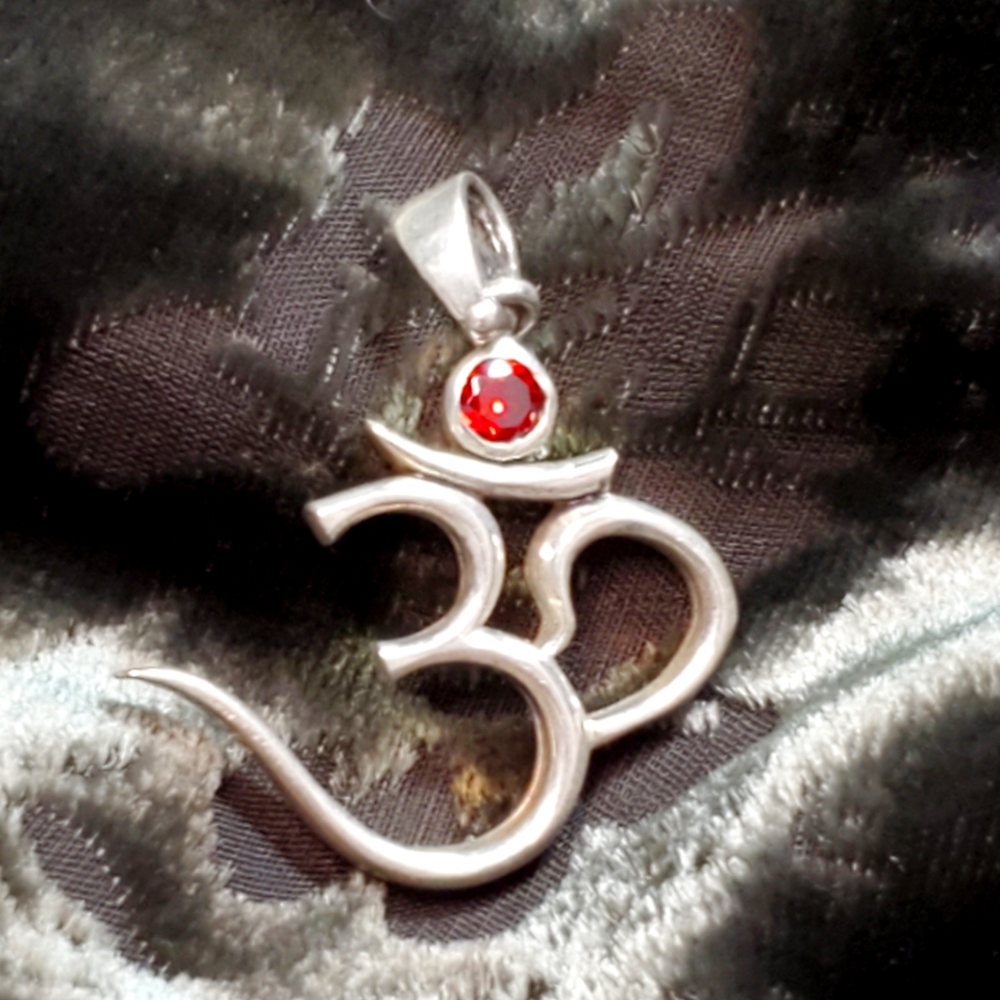 Sterling silver & garnet ohm symbol pendant.